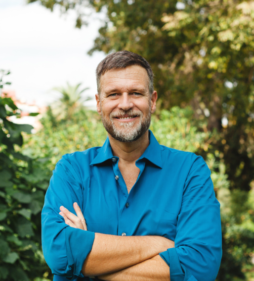 Man in a blue shirt crossing his arms