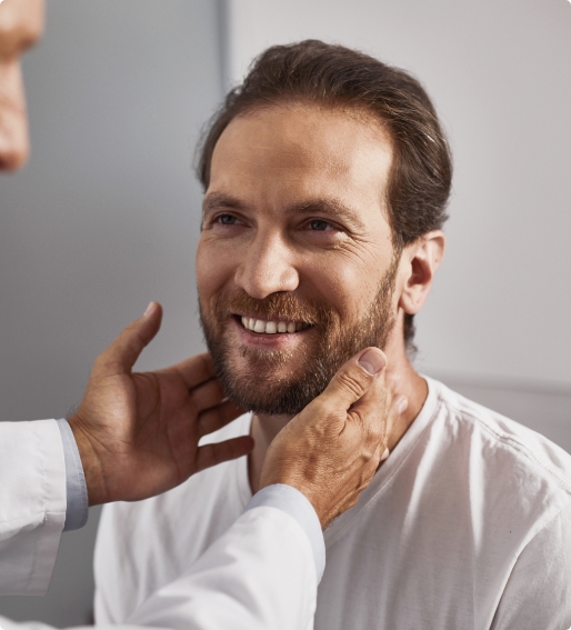Man getting his thyroid checked by doctor